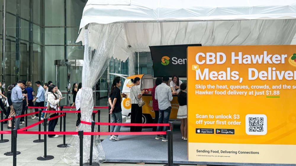 Send launch booth with a queue and “CBD Hawker Meals, Delivered” signage