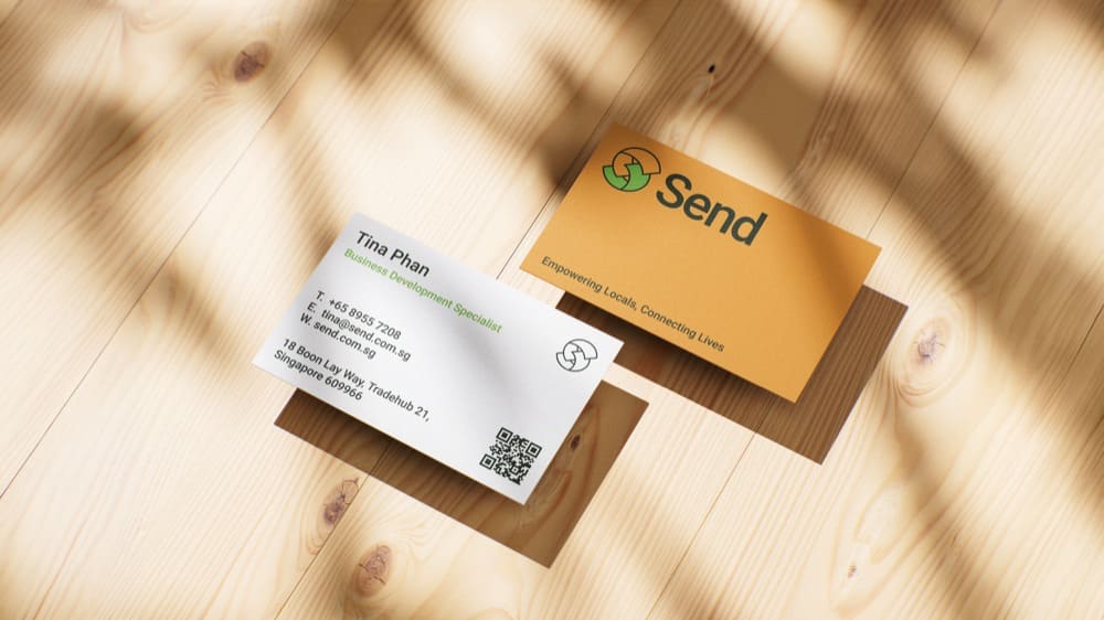 Send business cards on a wooden table