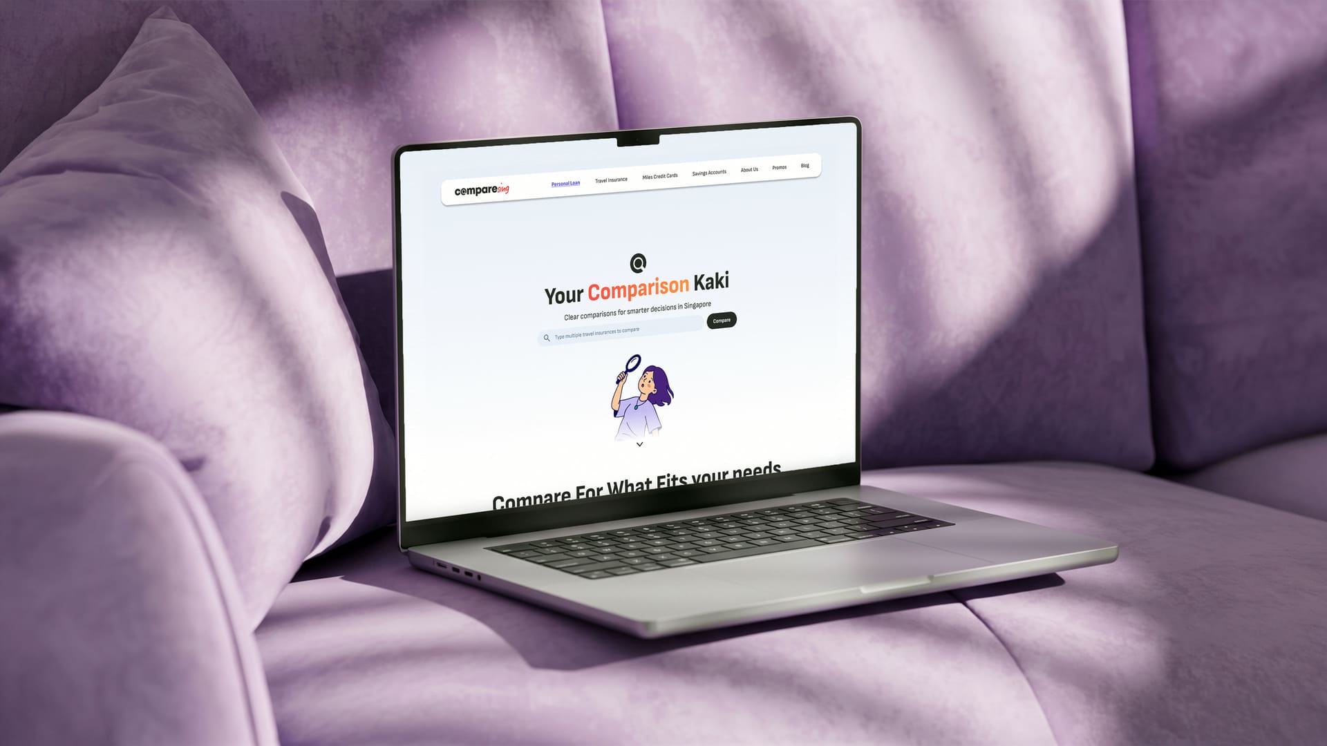 Laptop on a lilac sofa showing the CompareSing home page, “Your Comparison Kaki”